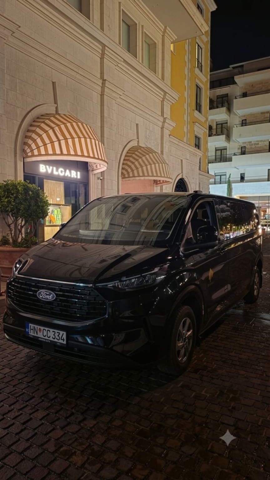 Limo4me vehicle parked outside Bvlgari at night