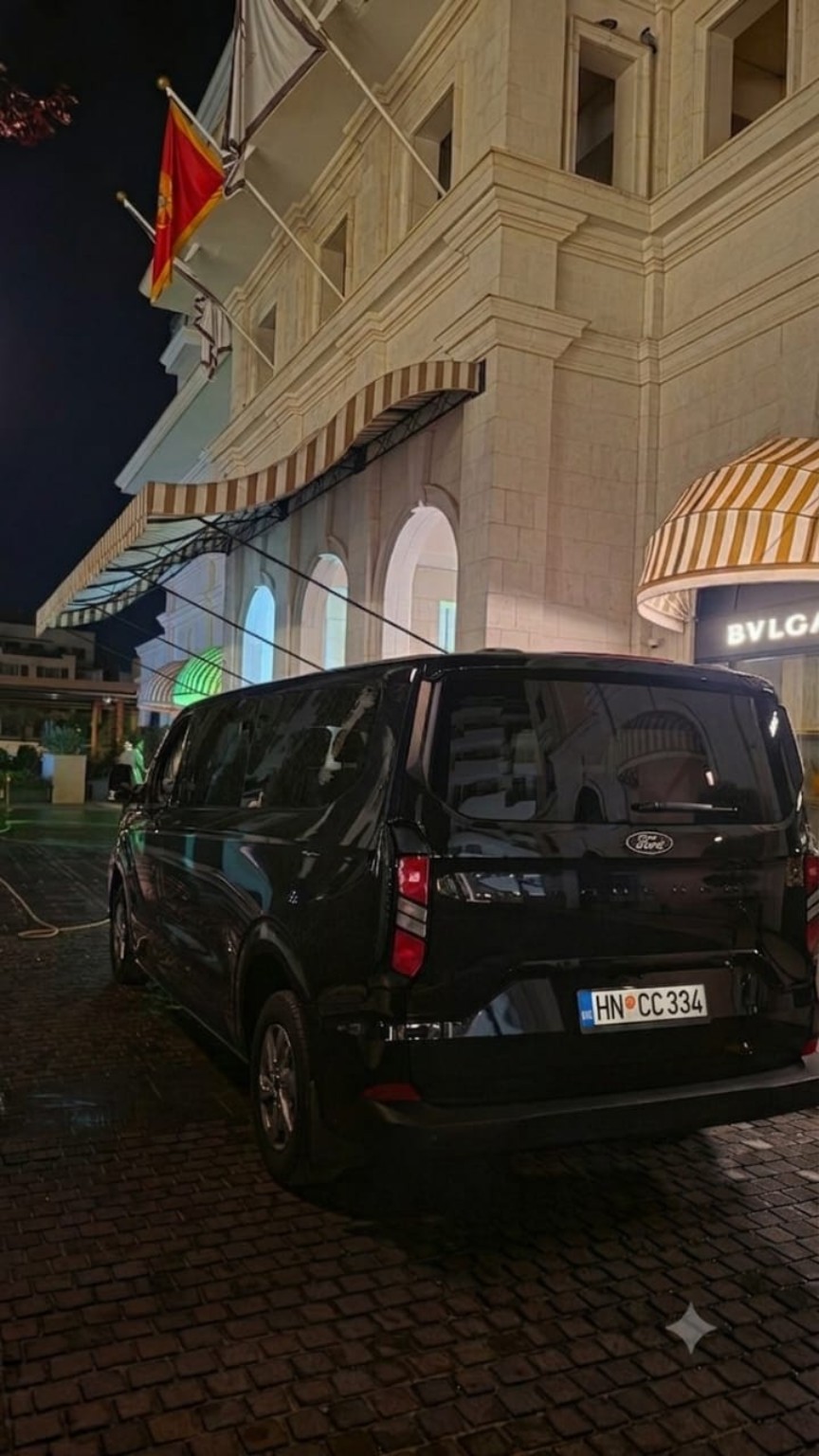 Rear view of the Limo4me vehicle outside Bvlgari at night